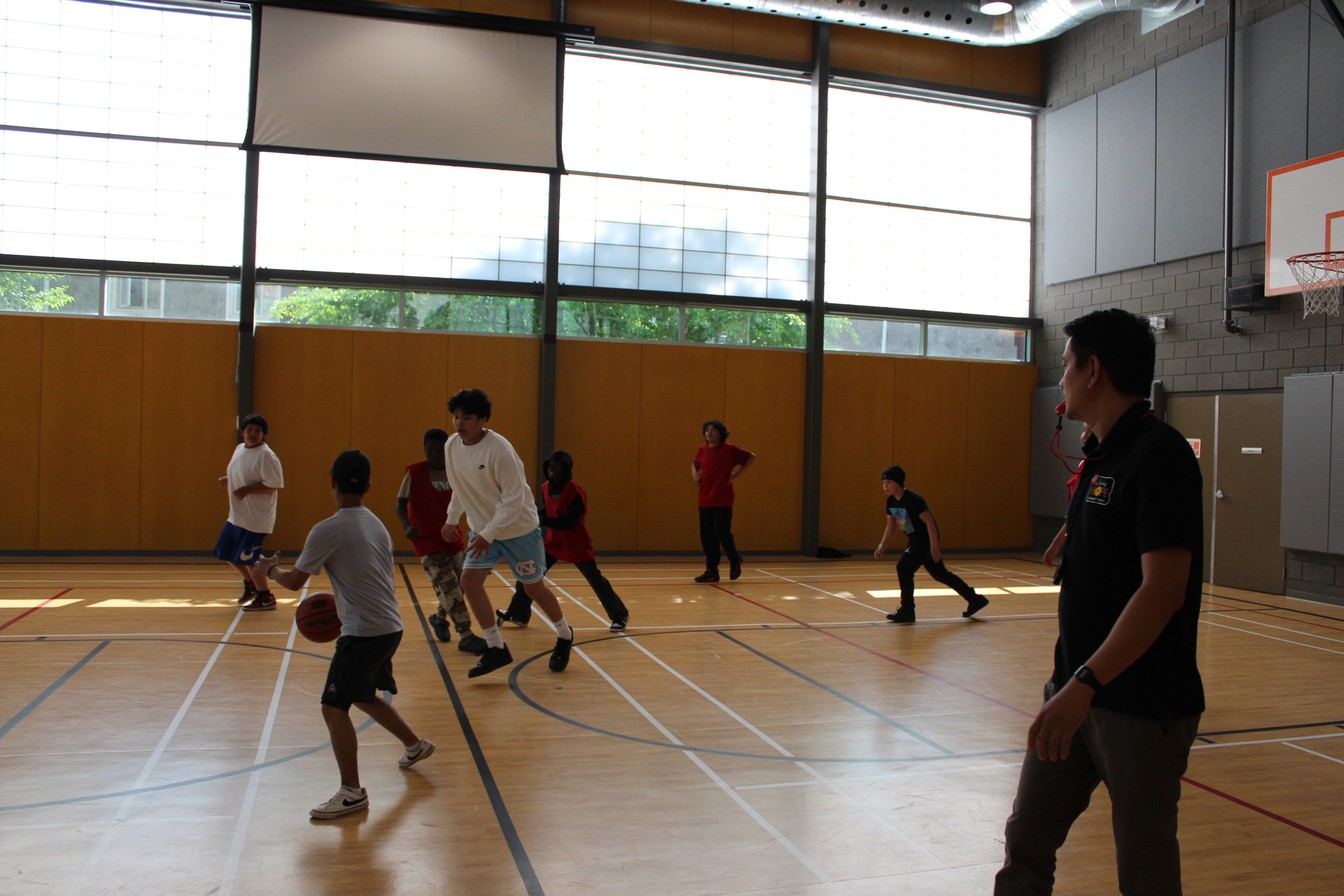 youths playing basket ball at the After School Activity Program offered by LHCC