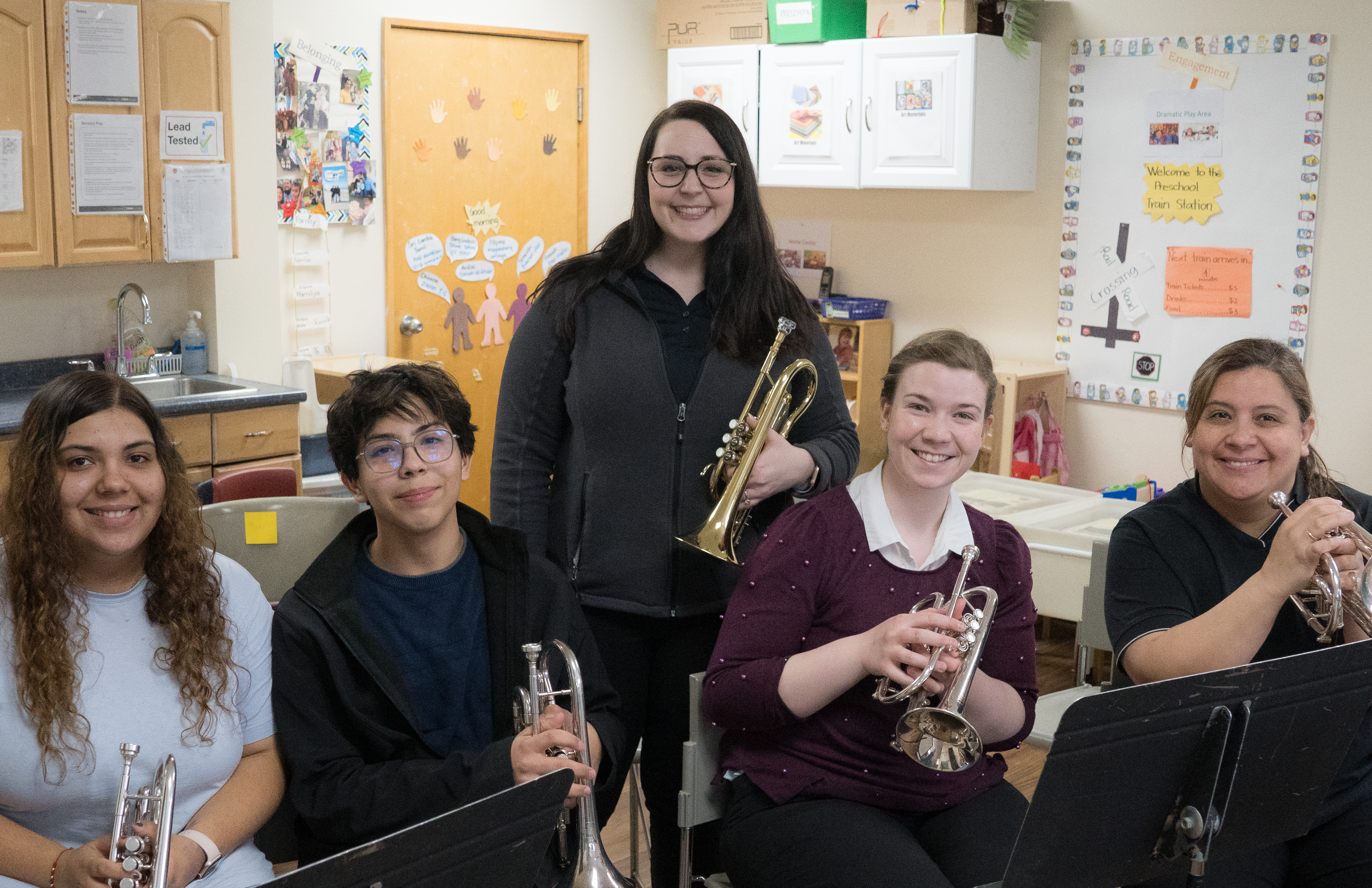 A band smiling at the camera