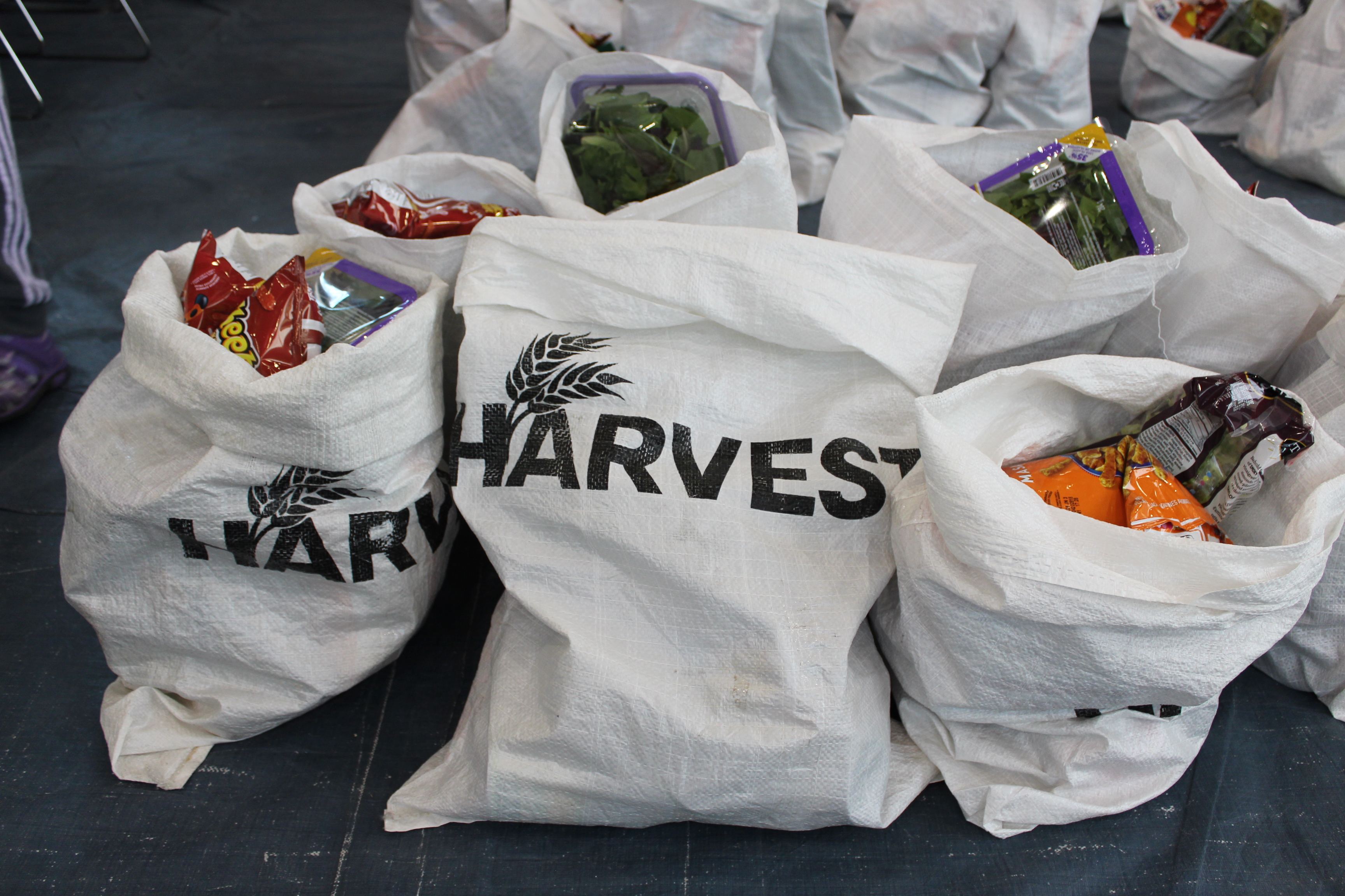 Food items packed in white Harvest branded bags